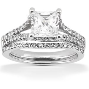 A silver engagement ring features a large square-cut center stone with smaller round stones along the band.