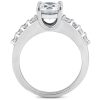 Silver ring featuring a large central clear gemstone with smaller clear stones set on the band.