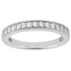 A silver band ring is adorned with a row of clear, sparkling stones along its outer edge.