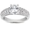 A silver ring features a large central diamond surrounded by smaller sparkling stones on its band.