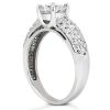 A silver engagement ring featuring a large central diamond and smaller stones set along the band.