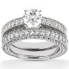 Silver engagement ring set featuring a large round center diamond and intricate pave detailing on the band.