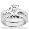 A silver twisted band ring features a large round diamond set in the center.