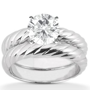 A silver twisted band ring features a large round diamond set in the center.