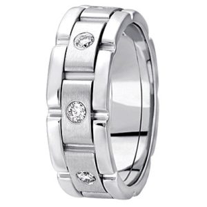 A silver ring with a brushed finish and three round, clear gemstones set within its band.