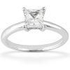 A silver ring features a princess-cut diamond set in a four-prong setting.