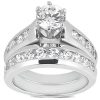 A silver engagement ring set featuring a prominent round diamond surrounded by smaller diamonds on the band.