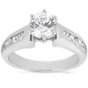 A silver engagement ring features a round central diamond with smaller stones set on either side.