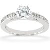 A silver engagement ring featuring a large round diamond surrounded by smaller accent stones.
