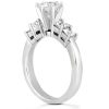 A silver engagement ring featuring a large central diamond and three smaller diamonds on each side.