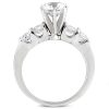 A silver engagement ring with a large central diamond and four smaller diamonds on either side.