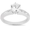 A silver engagement ring featuring a large round diamond center stone and two rectangular stones on either side.