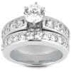 A silver wedding ring set featuring a central round diamond and smaller diamonds embedded in the band.
