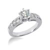 A silver engagement ring features a central round diamond and smaller diamonds set along the band.