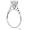A silver engagement ring with a large, clear diamond in a pronged setting is displayed prominently.