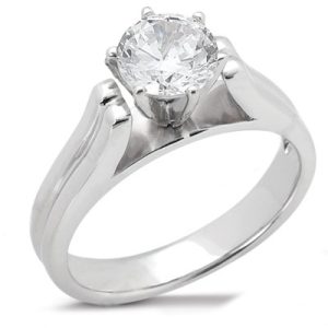 A silver engagement ring features a prominent round-cut diamond set in a six-prong mount.