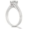 A silver engagement ring with a clear round gemstone positioned prominently at the top.