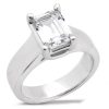 A silver ring features a large, clear, rectangular gemstone set in a four-prong setting.