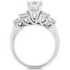 A silver engagement ring features a large central gemstone surrounded by four smaller stones in a flowing design.