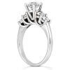A silver ring featuring a large solitaire diamond at the top, surrounded by smaller diamonds in a decorative setting.