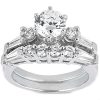A silver engagement ring featuring a large central round diamond surrounded by smaller diamonds and baguette-cut stones.