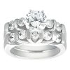 A silver-toned wedding ring set features a central round diamond surrounded by smaller diamonds on an intricately designed band.