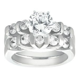 A silver-toned wedding ring set features a central round diamond surrounded by smaller diamonds on an intricately designed band.