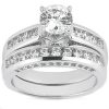 A silver engagement ring features a large central round diamond with smaller diamonds set along the curved band.