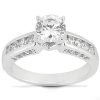 A silver ring with a large round diamond center stone and smaller diamonds set along the band.