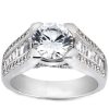 A silver ring features a large round diamond at the center and smaller stones set along the band.