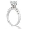 A silver engagement ring with a prominent round diamond setting.