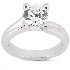 A silver ring features a large round diamond set in a four-prong setting.