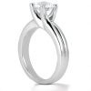 A silver engagement ring with a prominent round diamond set in a claw-like prong design.