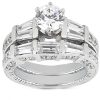 A silver engagement ring features a round center diamond surrounded by rectangular and smaller stones in a layered design.