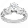 A diamond engagement ring with a large round center stone and tapered baguette side stones.