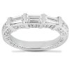 A silver ring featuring three long rectangular gemstones surrounded by smaller round stones.