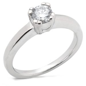 A silver engagement ring with a prominent single round diamond at the center.