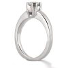 A silver engagement ring with a single diamond set in a raised prong setting is displayed against a white background.