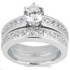 A silver engagement ring set featuring a prominent round gemstone surrounded by smaller stones along the band.