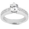 A silver engagement ring with a large central round diamond and smaller accents along the band is displayed.
