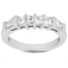 A silver ring features five sparkling clear gemstones arranged in a row.
