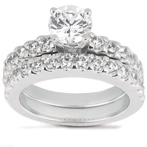 A diamond engagement ring featuring a large central stone and two rows of smaller diamonds on a white gold band.