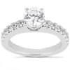A silver engagement ring featuring a central round diamond and smaller diamonds set along the band.