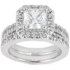 A silver engagement ring with a square-cut center diamond surrounded by smaller accent diamonds.