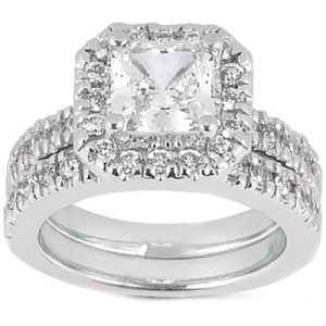 A silver engagement ring with a square-cut center diamond surrounded by smaller accent diamonds.