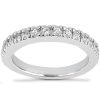 A silver ring adorned with small, round diamonds encircles a polished band.