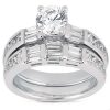 Two silver wedding bands, one featuring a round center diamond and the other with multiple rectangular diamonds, are displayed together.