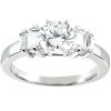 A silver engagement ring featuring a large round diamond in the center flanked by two smaller rectangular diamonds.