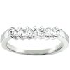 A silver ring with five sparkling clear gemstones set in a row.