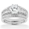 A diamond engagement ring set features a round center stone surrounded by smaller diamonds on a silver band.